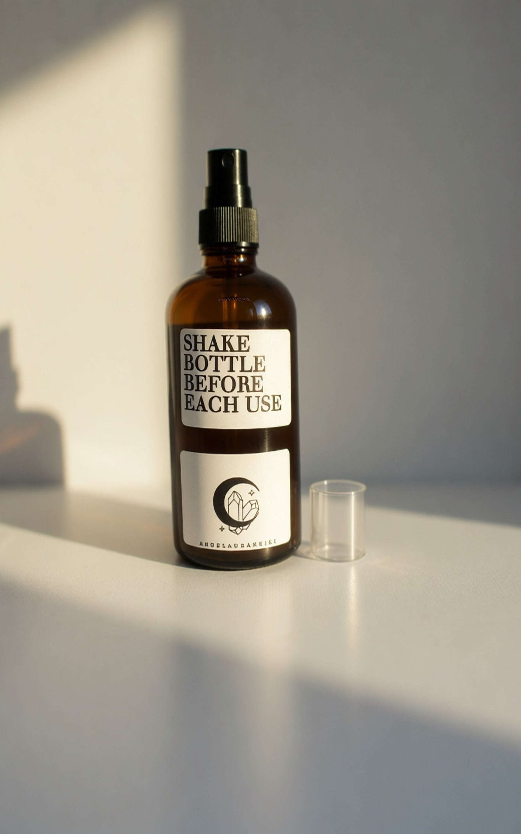 Apothecary style amber spray bottle of Thymes Natural Deodorant with crescent moon logo